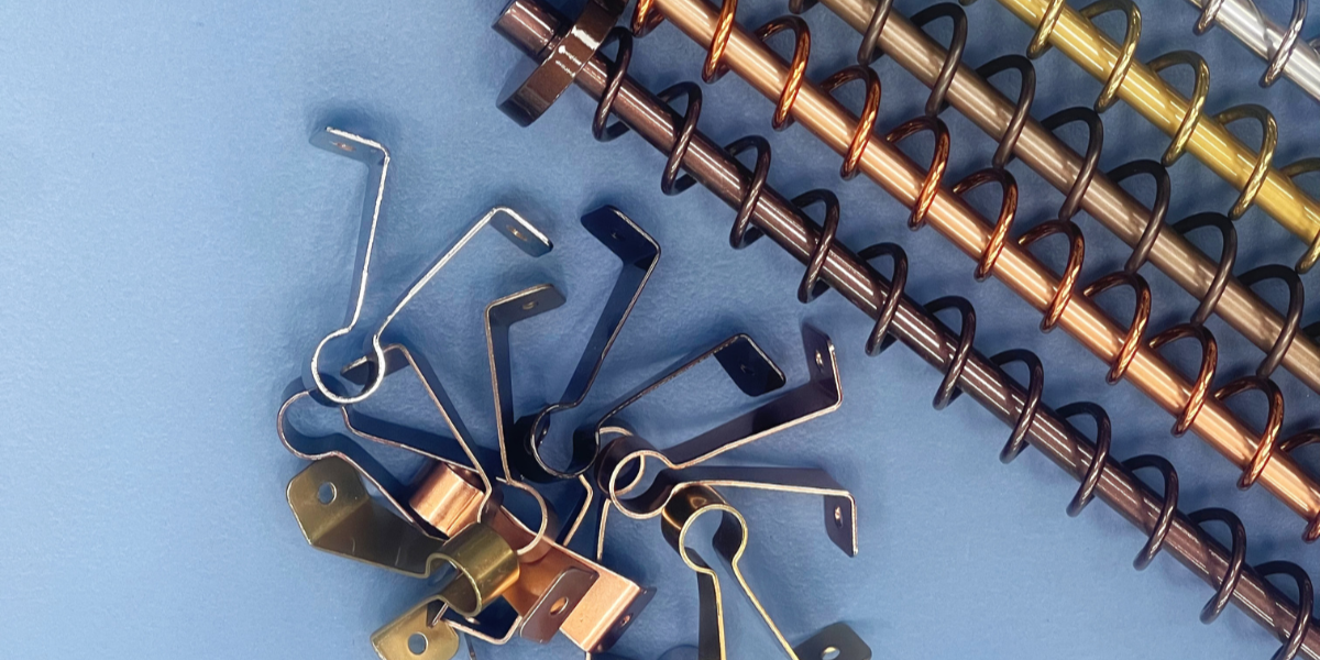 Various colour clothes rails, next to a pile of wall attachments for the rail.