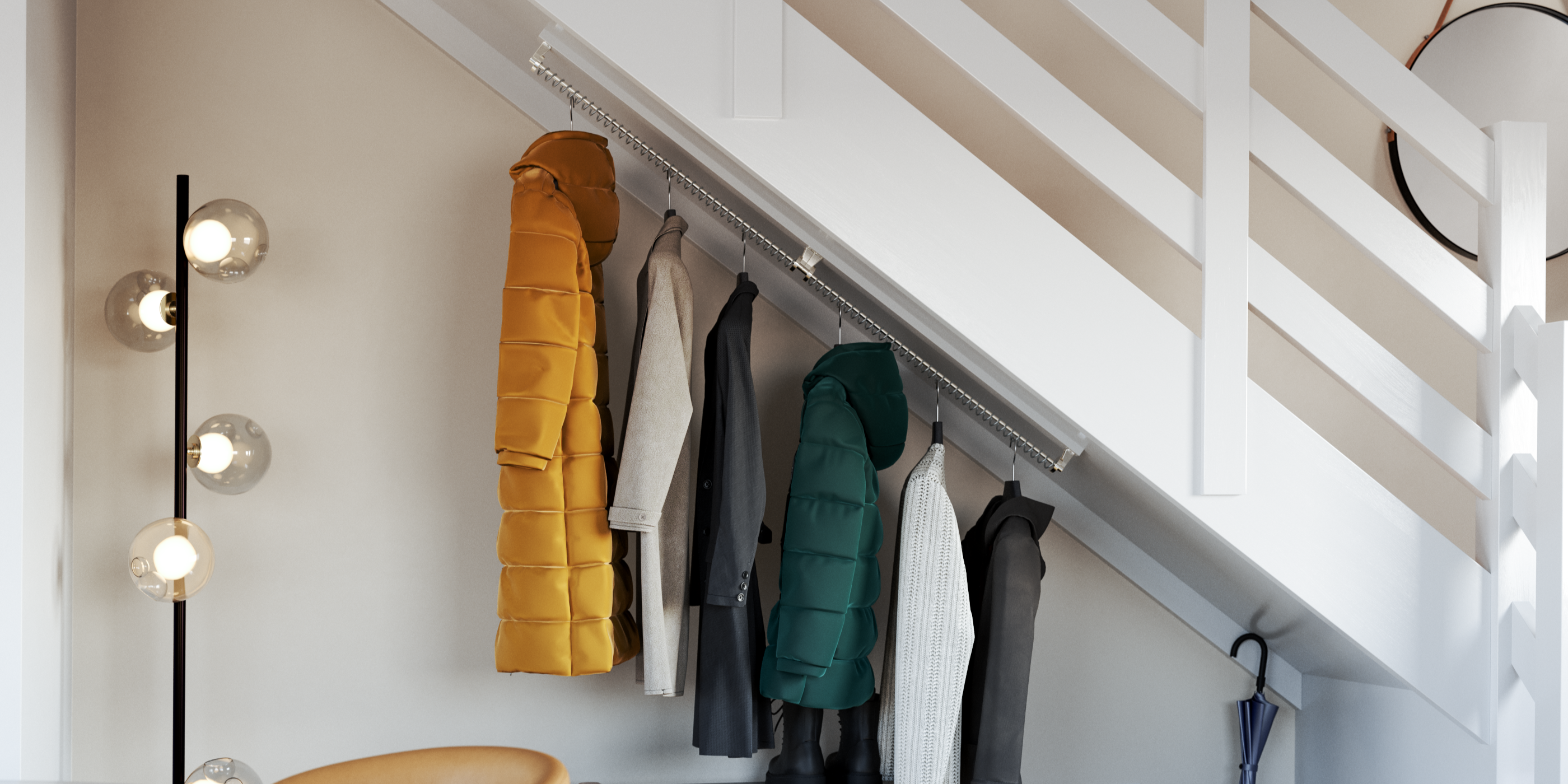 Zebedee clothing rail fitted to the bottom of a floating staircase. Coats are hanging from the railing.