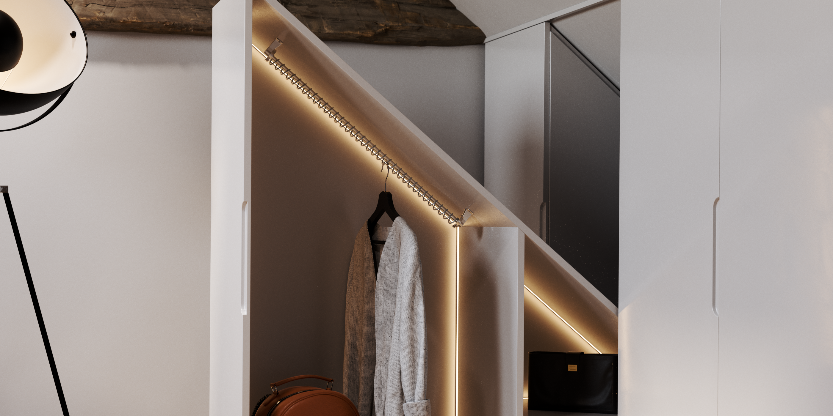 Cardigan hanging from a 45 degree angle rail inside a sloped cuboard.