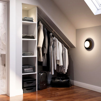 An attic bedroom showing zebedee sloping hanging rails set into the under eaves open closet.