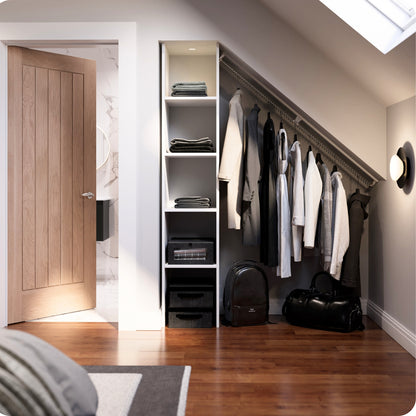 Modern open attic room closet area with sloped wardrobe rails, shelves, clothes, and bags in a well-lit loft bedroom.