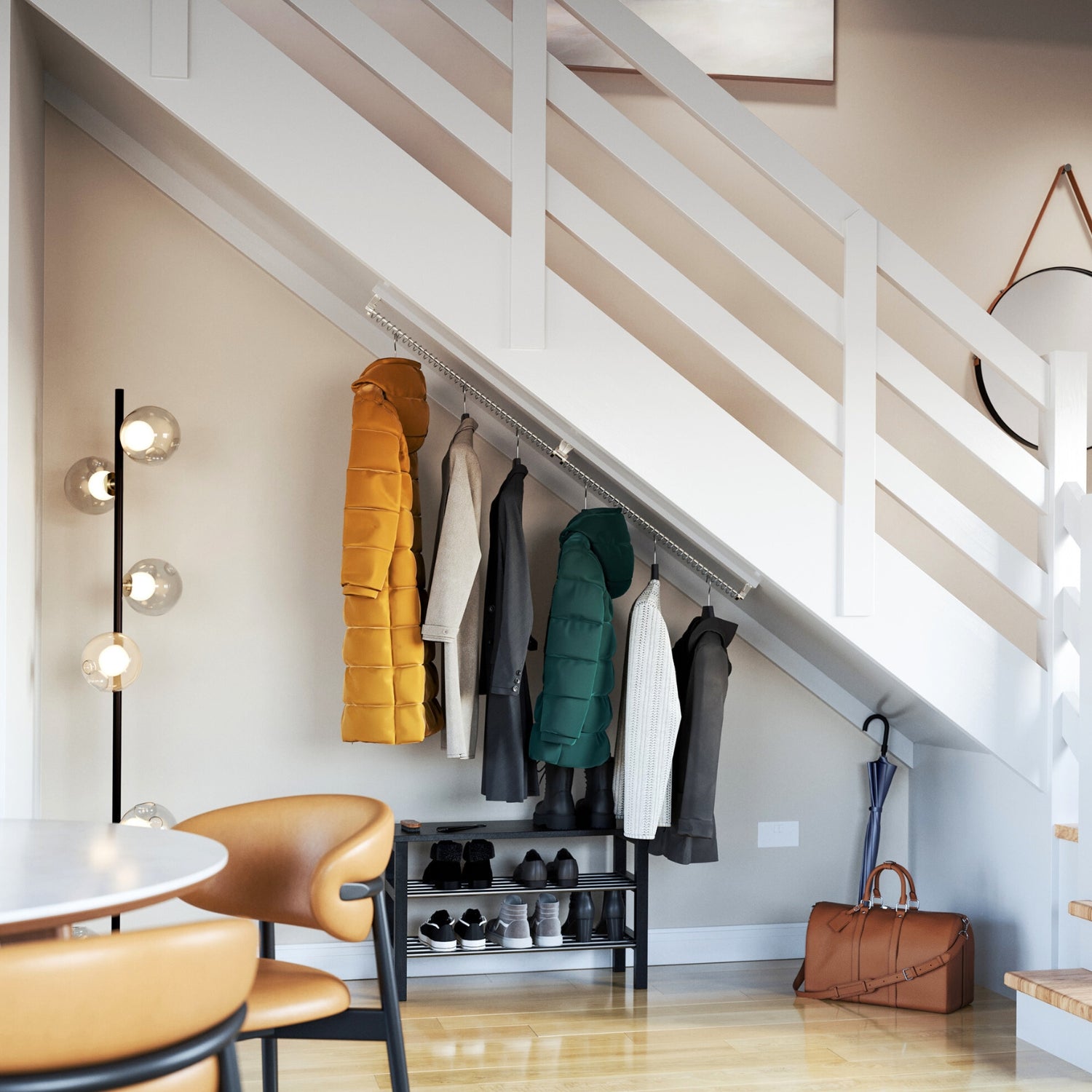 Coats hanging under a staircase from an angled clothes rail in a modern open plan  living room.