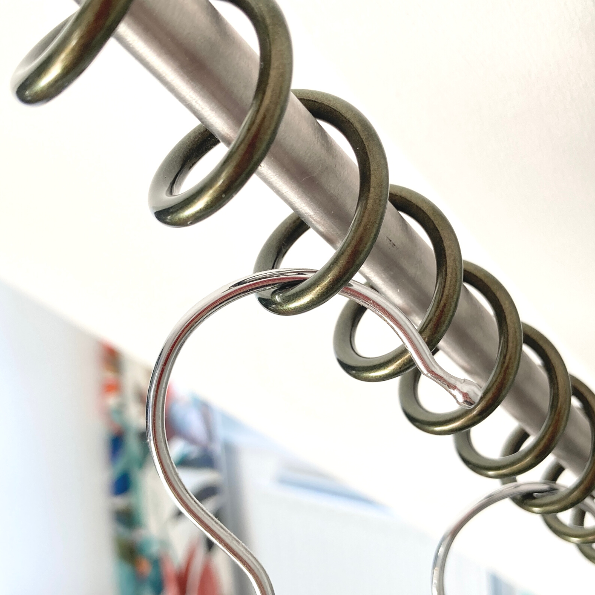 Close-up of a zebedee angled hanging rail coat hooks on a blurred background